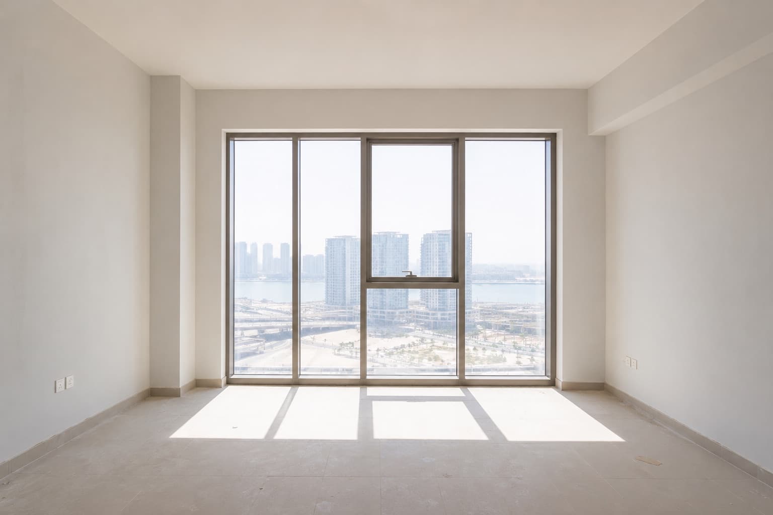 Before: an undressed apartment window, midday sun falling straight onto bare floor