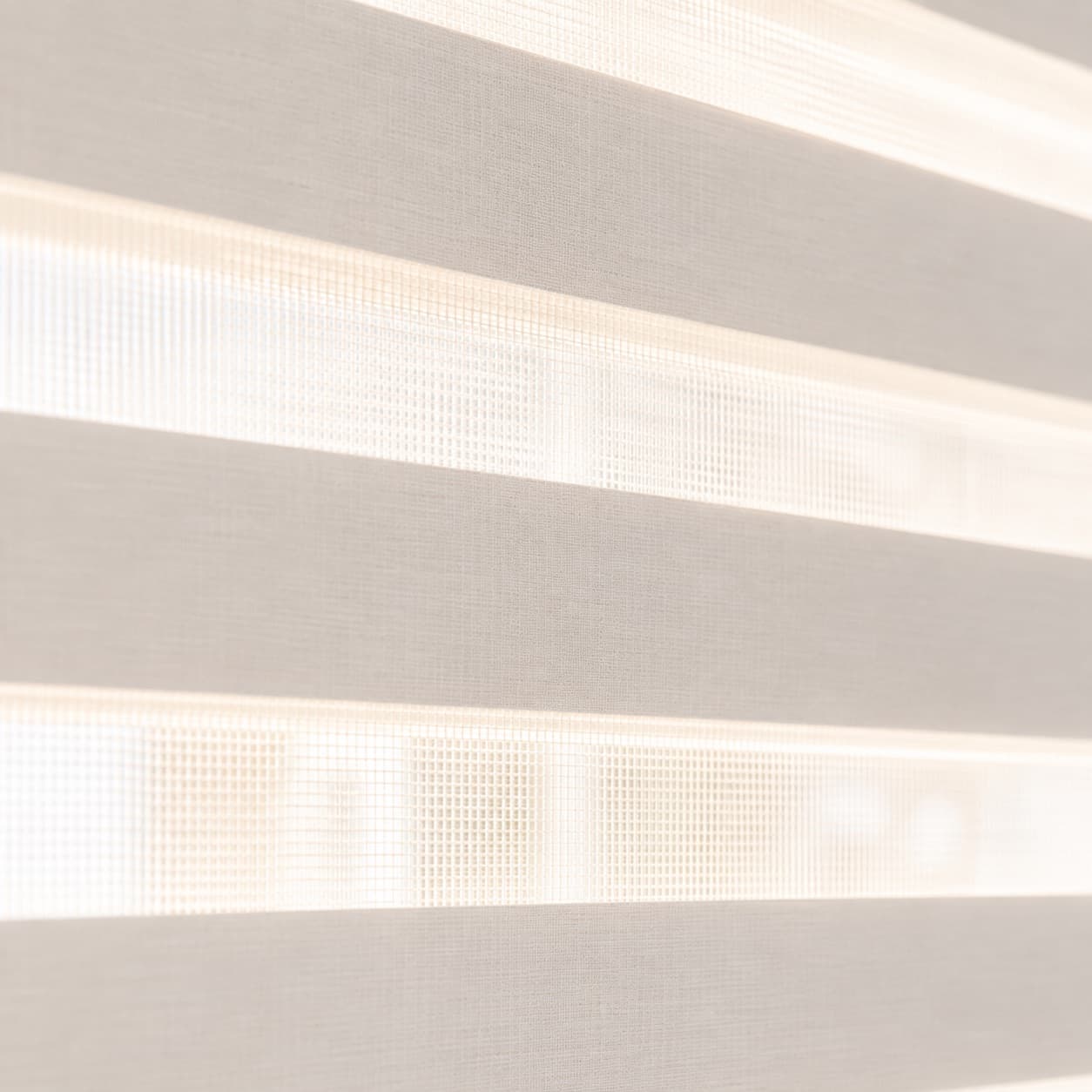 Zebra blind, alternating sheer and opaque bands backlit